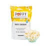 Poppy Handcrafted Popcorn White Cheddar bag with a bowl of gourmet cheesy popcorn on a blue background