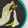 Kanibal & Co candlelight embroidered patch with hand and candle design on black fabric