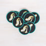 Kanibal & Co candlelight embroidered patch with hand holding a lit candle on black fabric