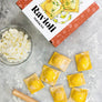 DIY ravioli making kit by Farm Steady Brooklyn Brew Shop with fresh ravioli, cheese, and pasta cutter on marble surface