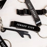 Black Jersey City bottle opener keychain with white text on a metal key ring by Kanibal Co.