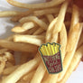 Kanibal & Co golden fries enamel pin with Nothing Gold Can Stay text on a pile of French fries