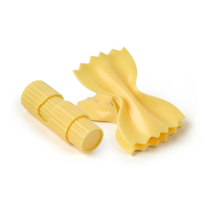 Two pieces of yellow pasta on a white background