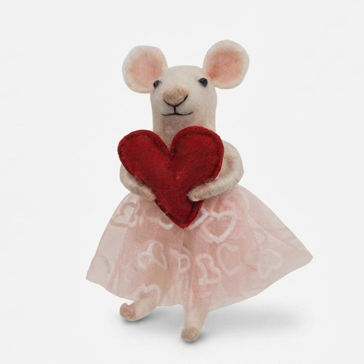 A small plush mouse figurine wearing a sheer light pink dress with white heart patterns and holding a red heart, photographed against a clean white background.