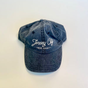 black baseball hat with white script lettering