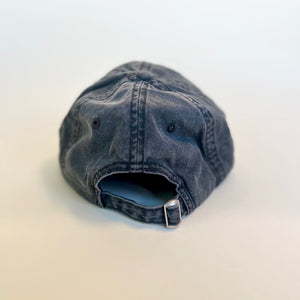 back of black baseball hat with adjustable strap