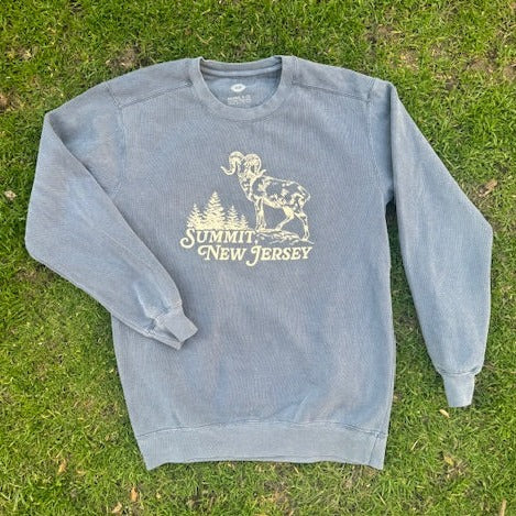 Blue crewneck sweater with a ram atop a mountain with trees in the background that reads Summit, NJ.
