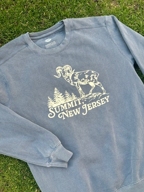 Blue crewneck sweater with a ram atop a mountain with trees in the background that reads Summit, NJ.