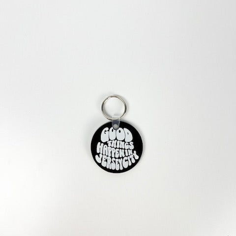 Round black tag with white text on a white background