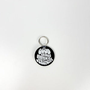 Round black tag with white text on a white background