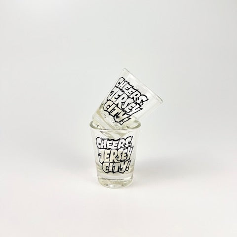 Two shot glasses with text on a white background