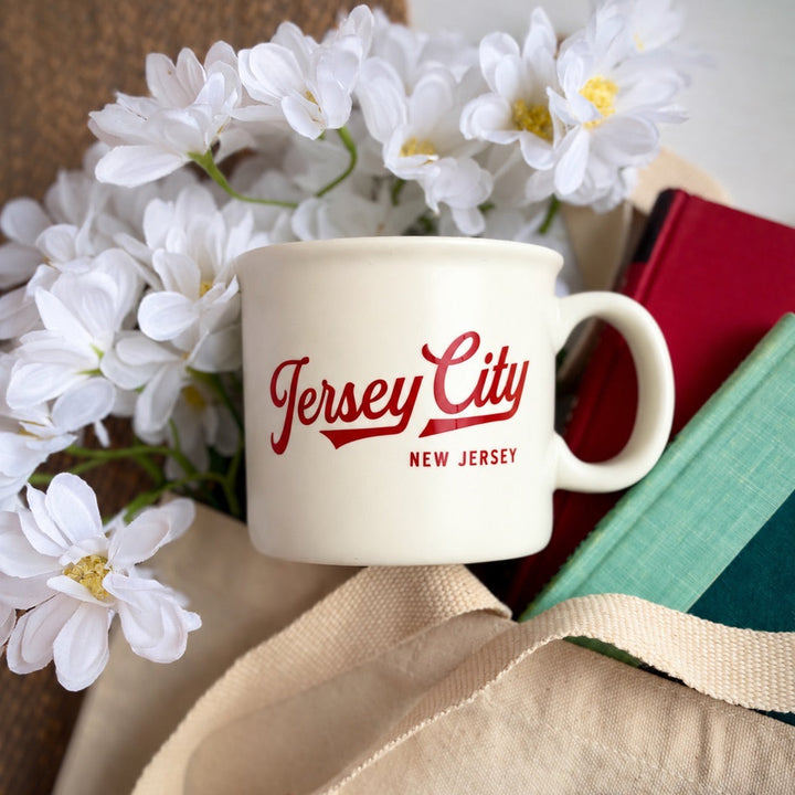 A cream ceramic mug with &