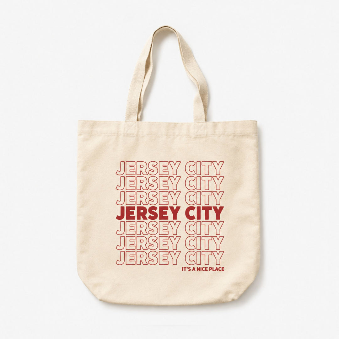 Beige tote bag with 'Jersey City' text in red on a white background