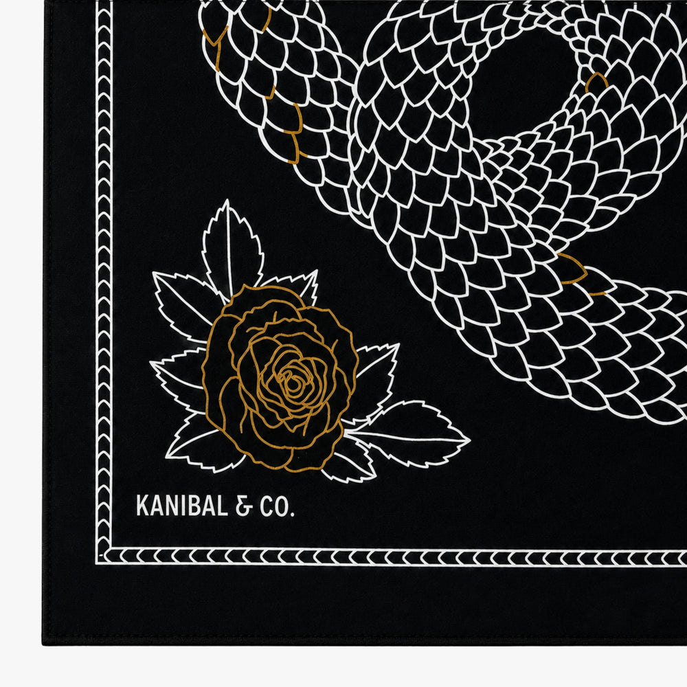Black bandana with white snake design, gold rose, and 'KANIBAL & CO.' text.