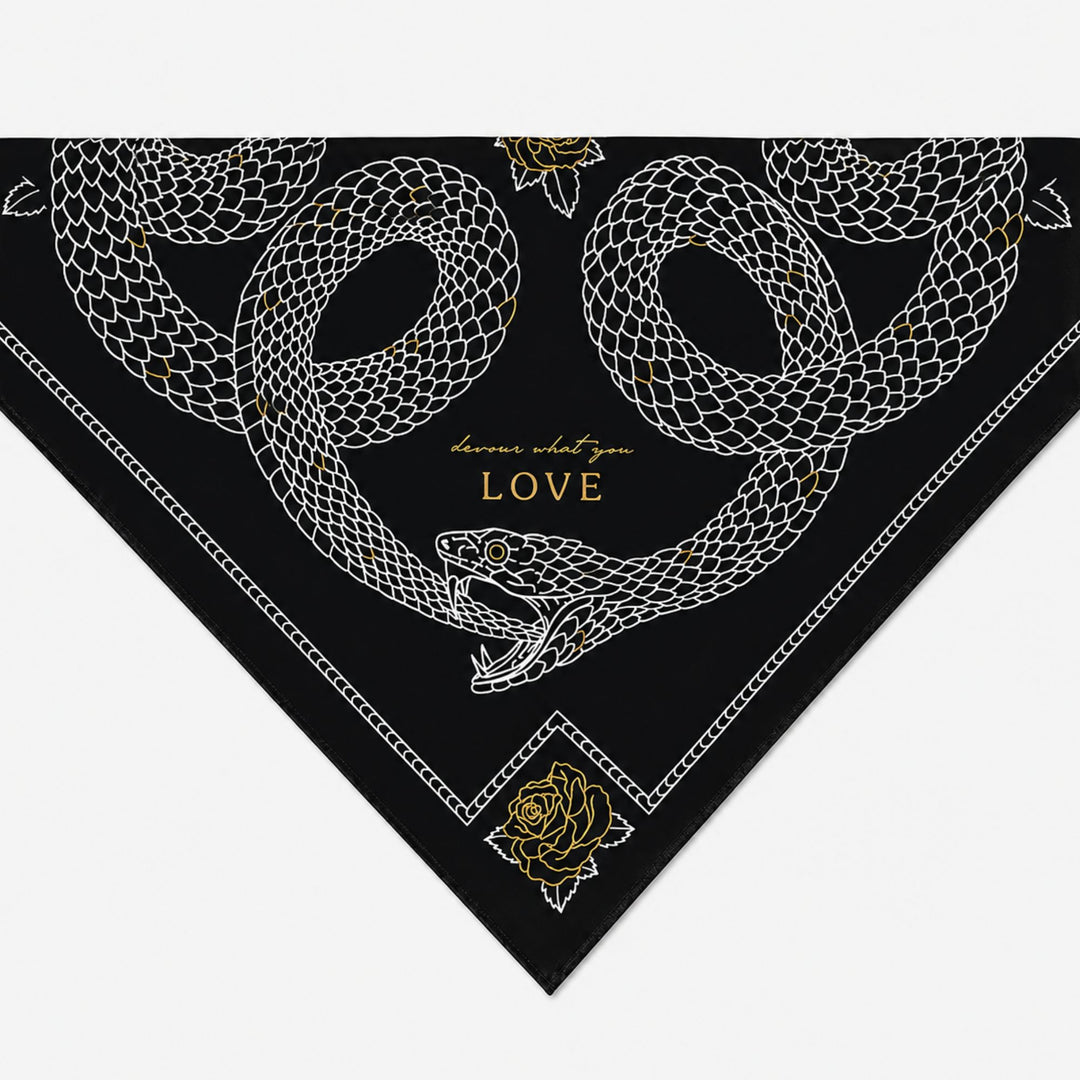 Black bandana with white snake design and gold text on a white background