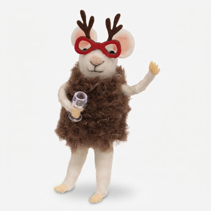 A plush felt animal doll shaped like a small deer or mouse with brown antlers, red glasses, a fuzzy brown body, and cream-colored legs, holding a small clear glass with amber liquid against a light gray background.