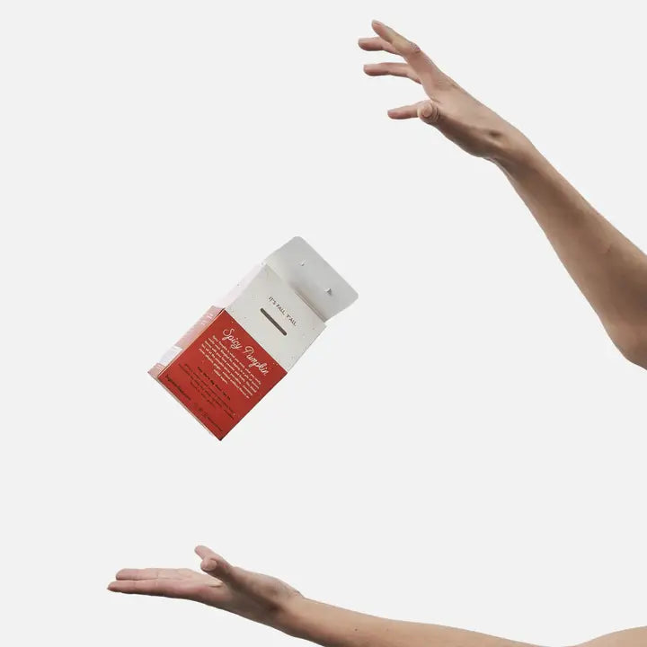 Big Heart Tea Co. Spicy Pumpkin Tea package floating above a hand with a minimalist background