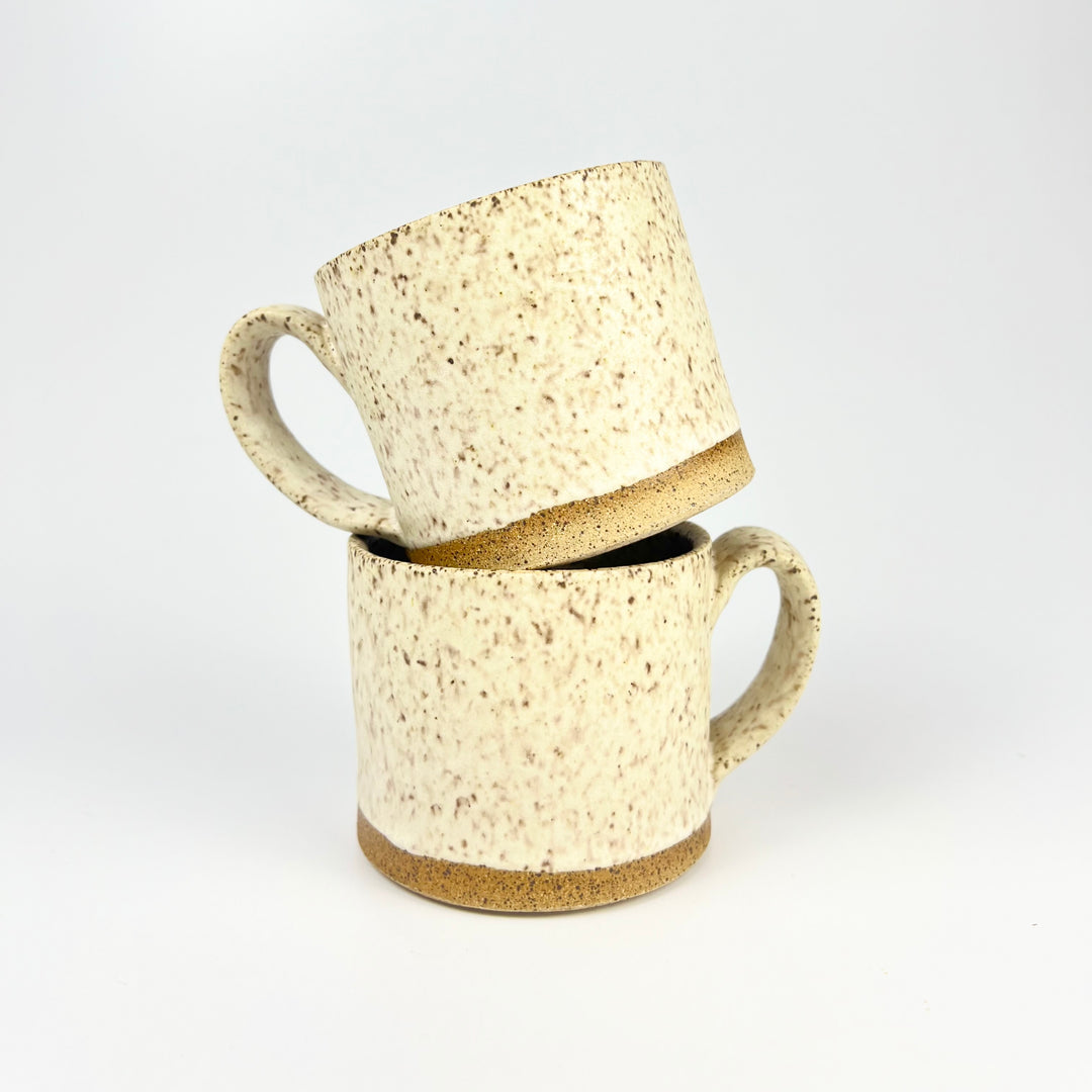 Stacked ceramic speckle mugs by Jordan B Ceramics with a rustic finish and comfortable handles