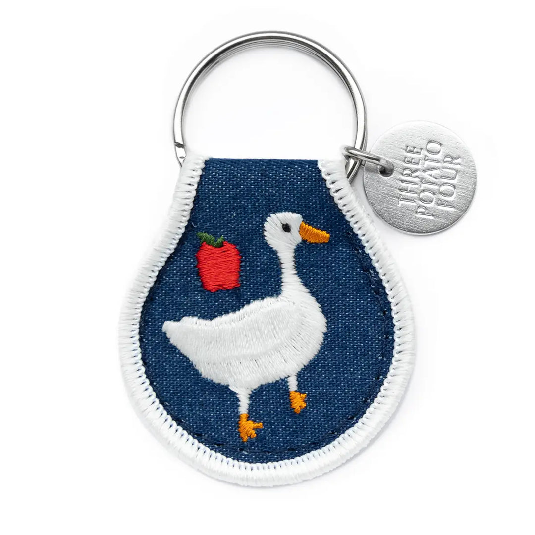 Cottage goose patch keychain featuring an embroidered goose design with a strawberry motif