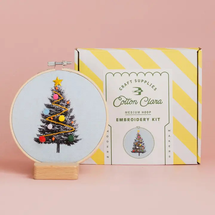Cotton Clara Christmas Craft Kit embroidery hoop with decorated Christmas tree and striped box