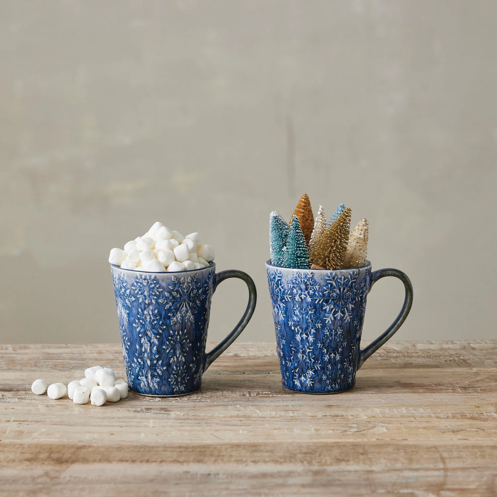 Creative Co-Op debossed ceramic mug in blue floral design filled with marshmallows