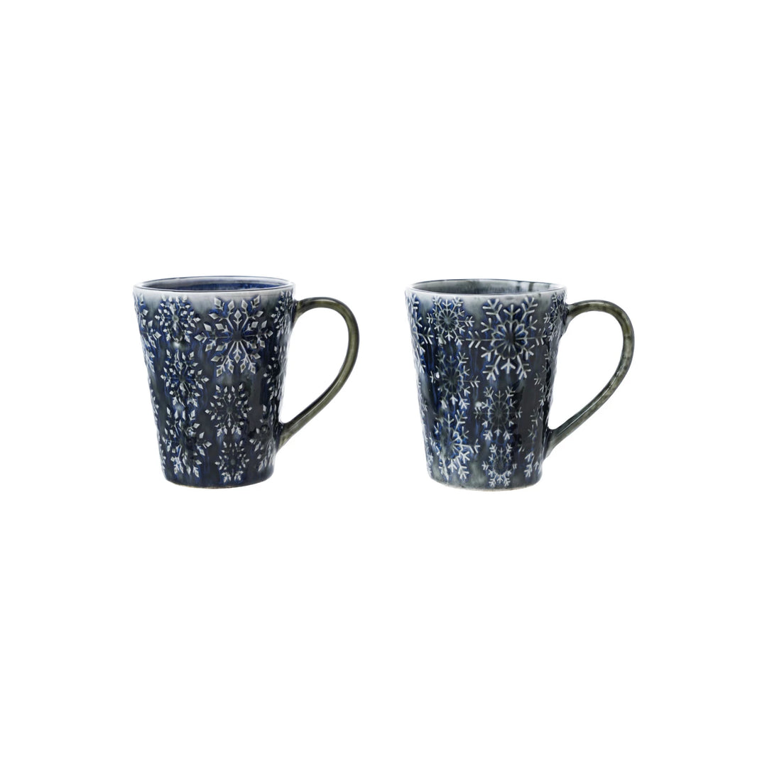 Set of two blue debossed ceramic mugs with intricate floral patterns for stylish beverage enjoyment