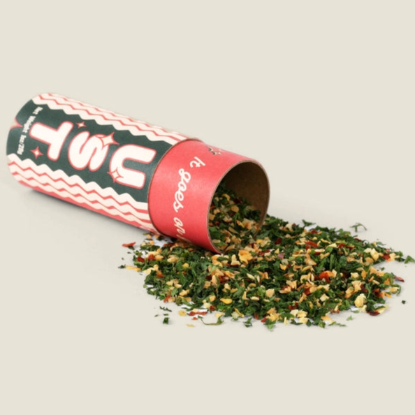 L'Isolina Pasta spaghetti dust seasoning spilled from a red and black container with dried herbs and spices