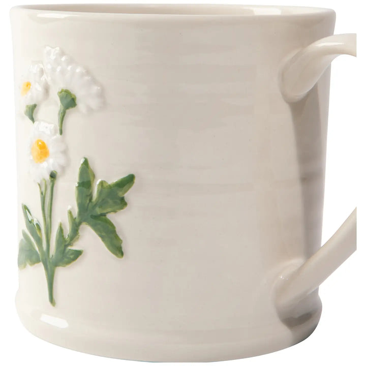 Danica embossed daisy mug featuring a floral design on a white ceramic surface