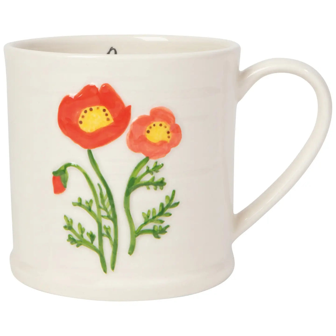 Danica embossed poppy mug featuring vibrant red poppy flowers and green stems on a white ceramic surface