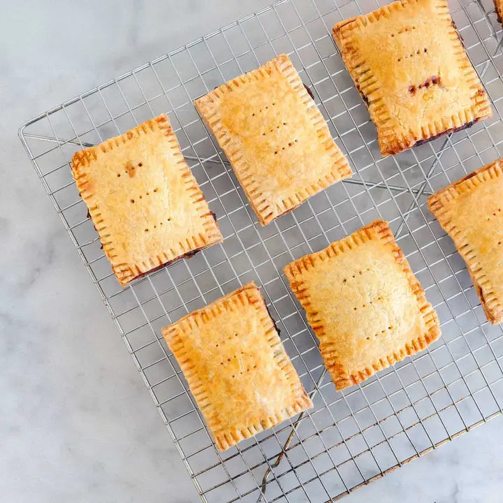 Freshly baked pastries on a cooling rack from a pastry tart DIY kit perfect for home baking enthusiasts