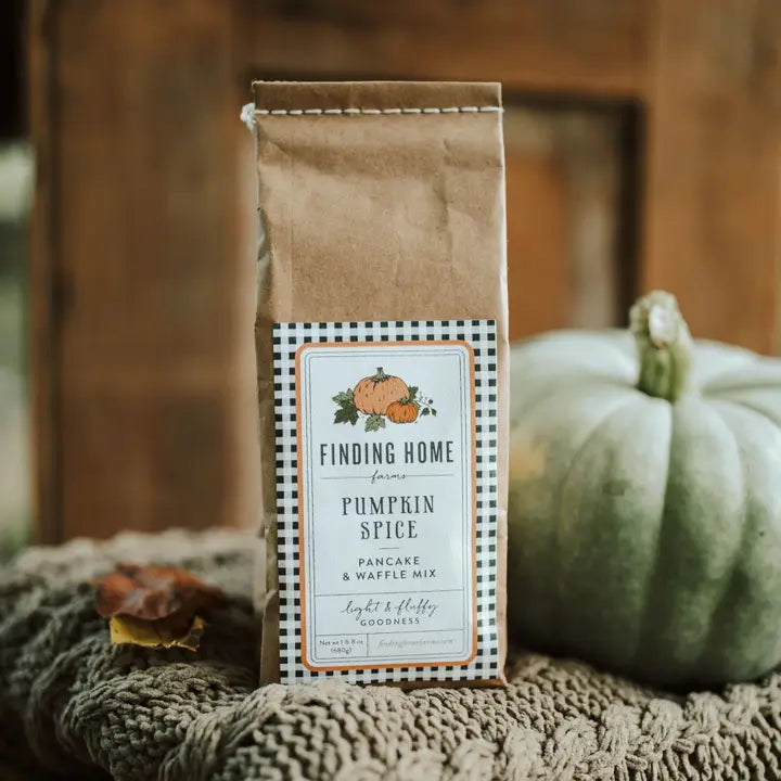Finding Home Farms Pumpkin Spice Pancake Mix in a kraft bag with a rustic backdrop