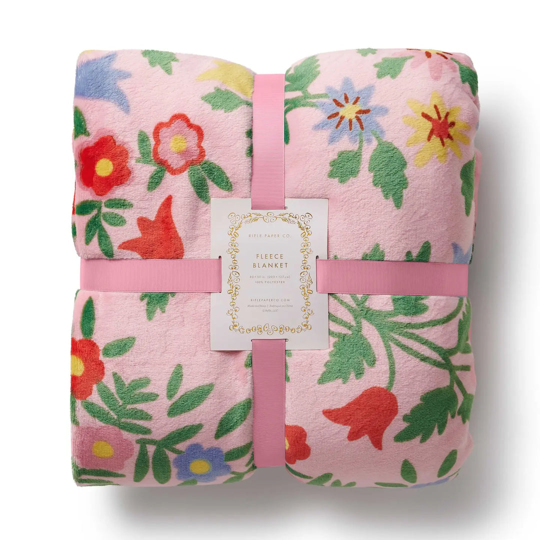 Rifle Paper Co. floral fleece blanket in pink with colorful floral patterns, perfect for cozy home decor