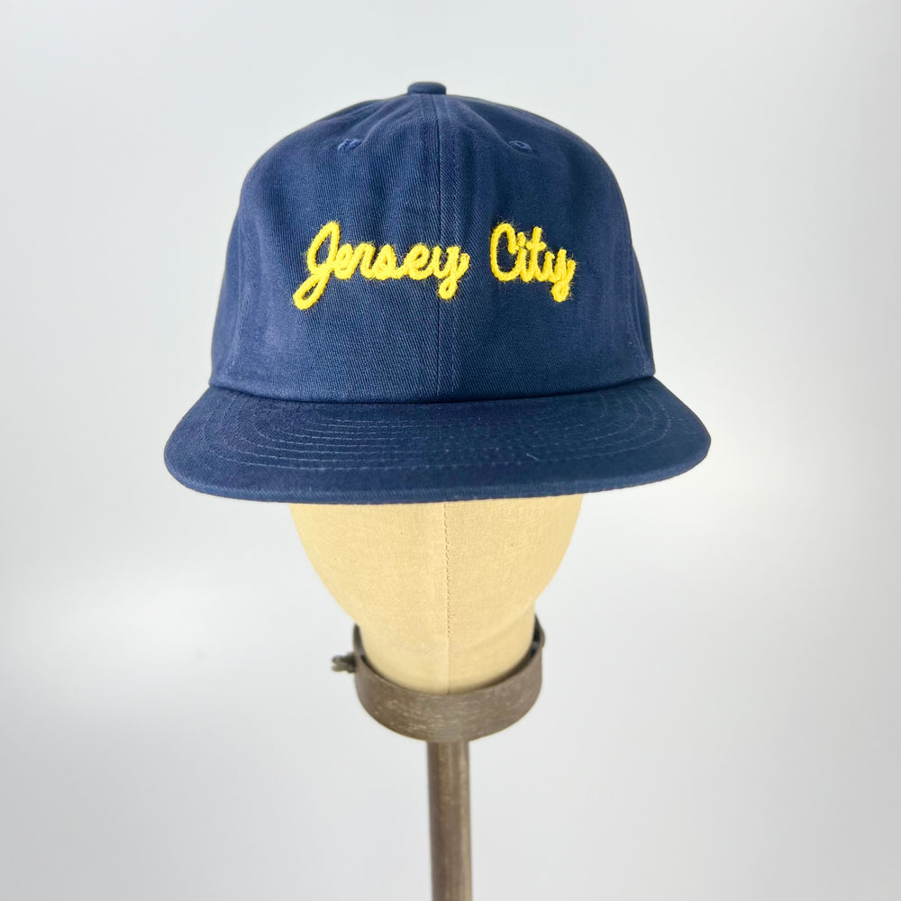 Weld MFG Jersey City embroidered hat in navy blue with yellow lettering on the front