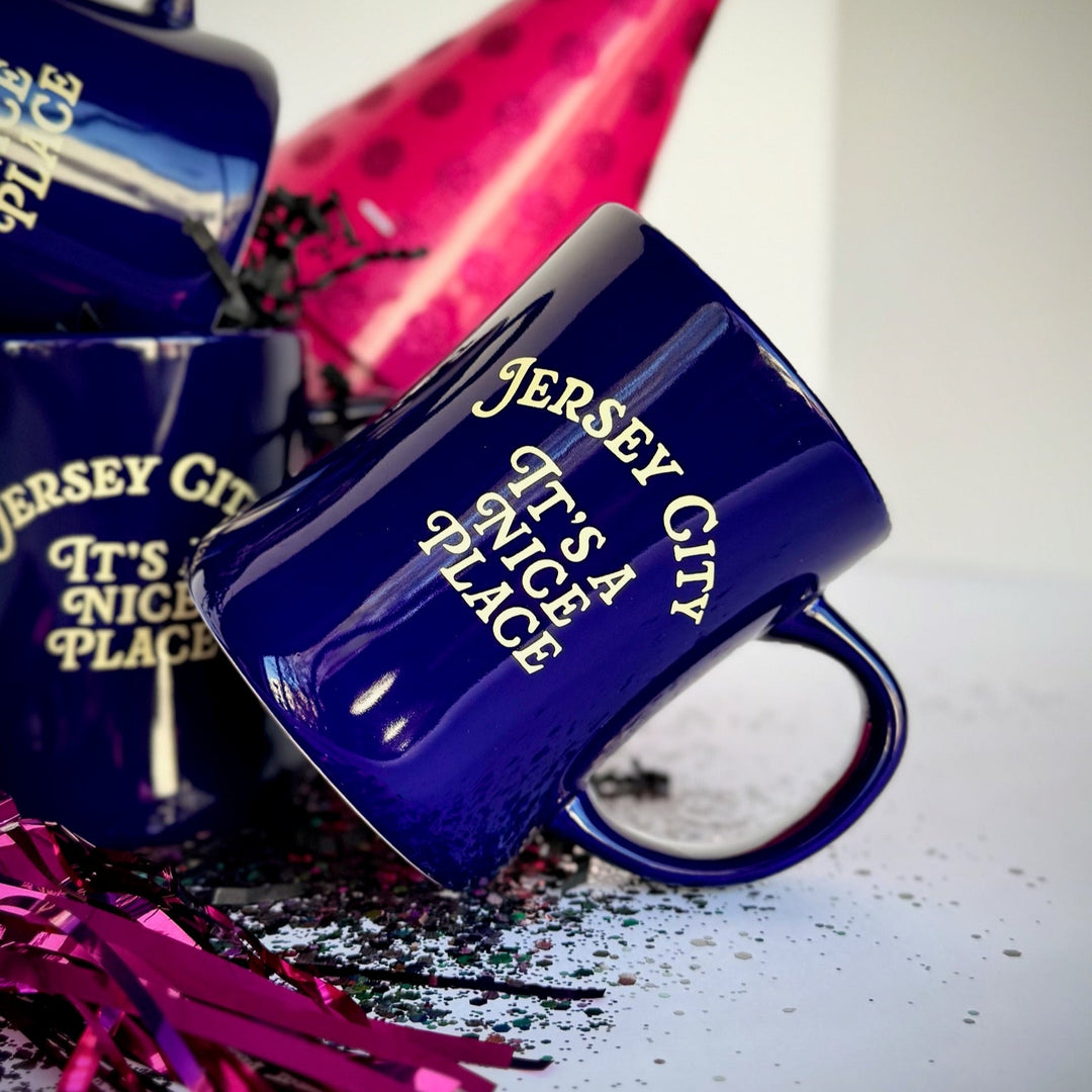 Kanibal & Co. navy blue Jersey City mug with the text It's a Nice Place on the side