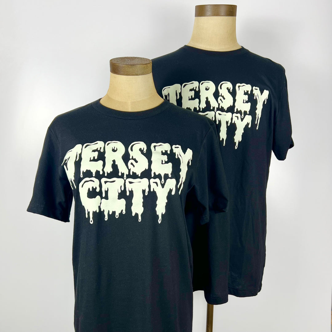 Kanibal & Co. Jersey City slime tee in black with white dripping text on front displayed on mannequins