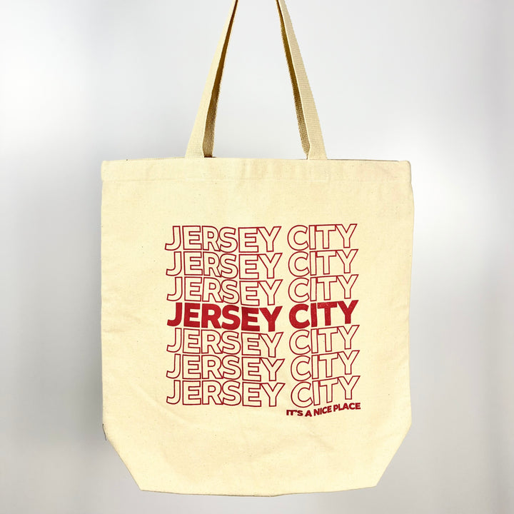 Jersey City tote bag by Vital Industries with repeated red text design on natural canvas fabric
