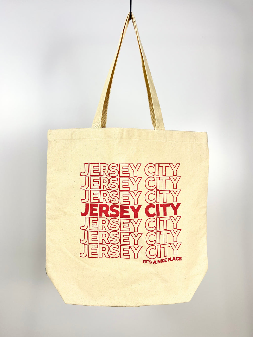 Vital Industries beige Jersey City tote bag with repeated red text design and long handles