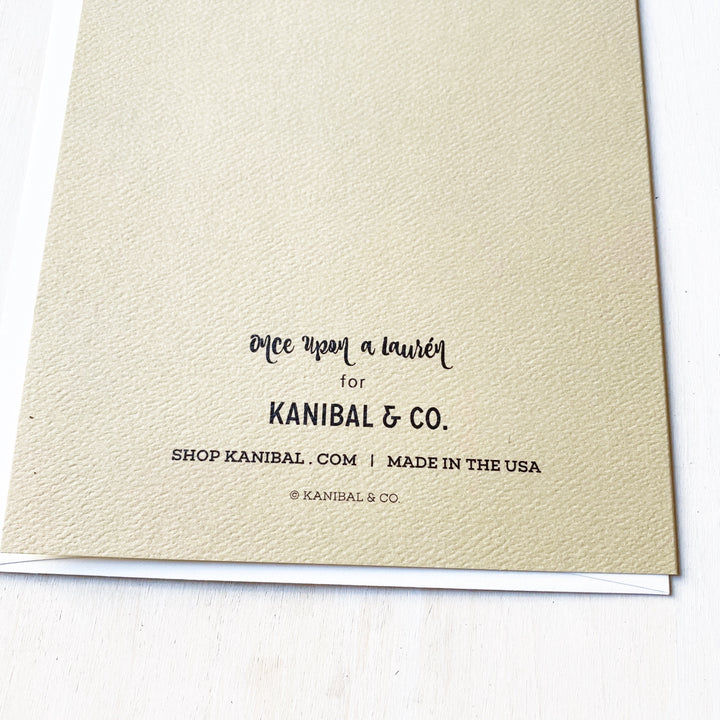 Back of a textured card from Kanibal & Co. featuring branding text for New Jersey holiday card