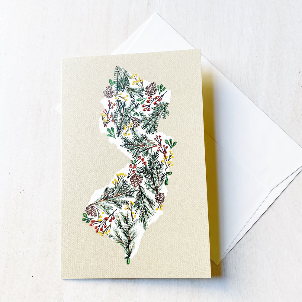 Kanibal Co New Jersey holiday card featuring pine cones and greenery illustration on textured paper