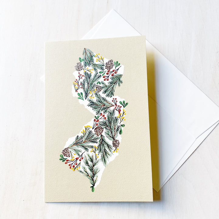 Kanibal Co New Jersey holiday card featuring pine cones and greenery illustration on textured paper