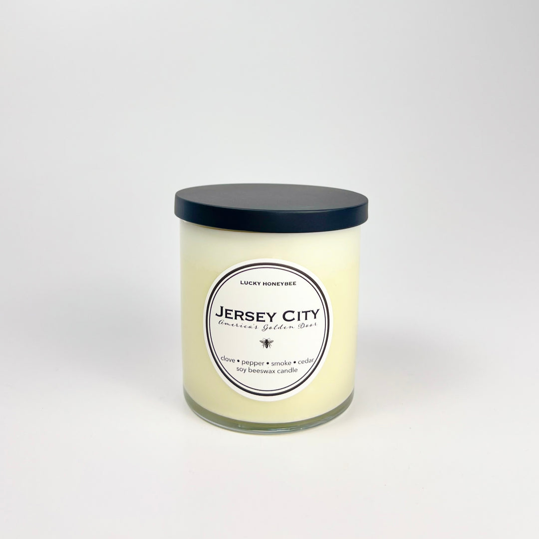 The Lucky Honeybee Jersey City candle in frosted glass jar with black lid beeswax scent for home decor