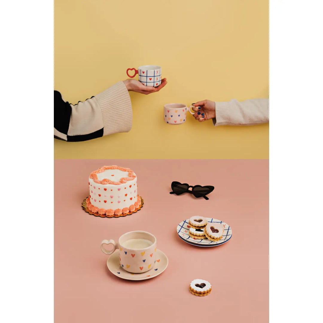 Danica mug sweet hearts displayed with cookies and cake against a colorful background