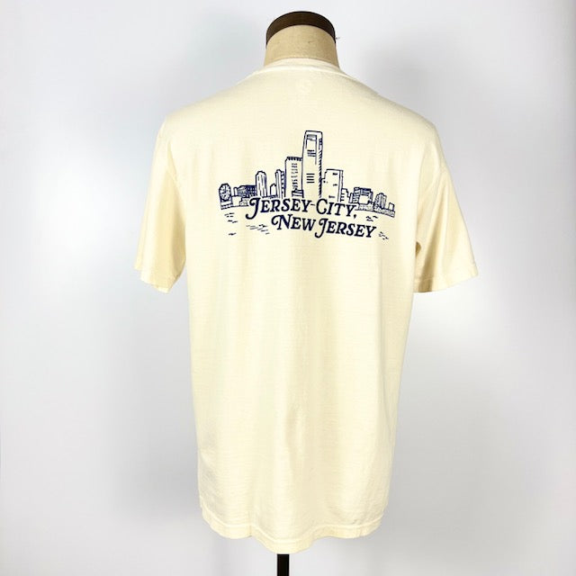 Back view of Nice Place Jersey City shirt by Kanibal Co with Jersey City skyline graphic in navy on cream fabric