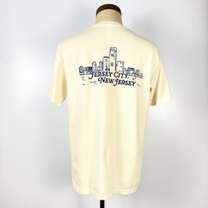 Back view of Nice Place Jersey City shirt by Kanibal Co with Jersey City skyline graphic in navy on cream fabric