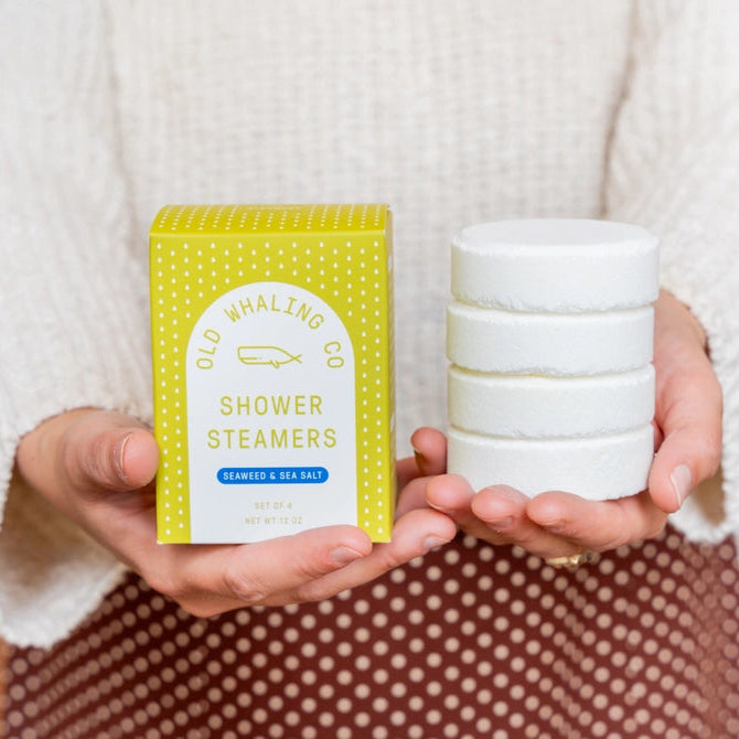 Old Whaling Co seaweed and sea salt shower steamers box with stacked white steamers held in hands
