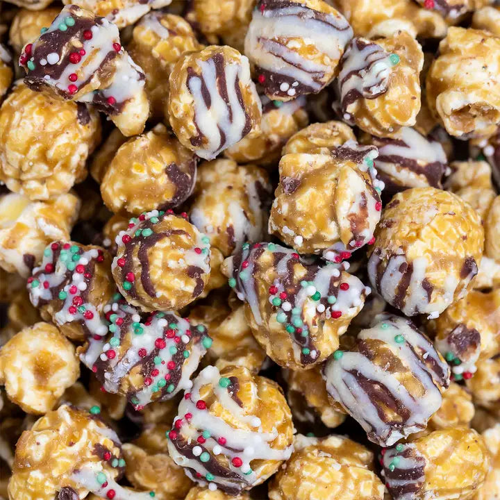 Delicious Poppy Handcrafted Christmas confetti popcorn with festive sprinkles and chocolate drizzle