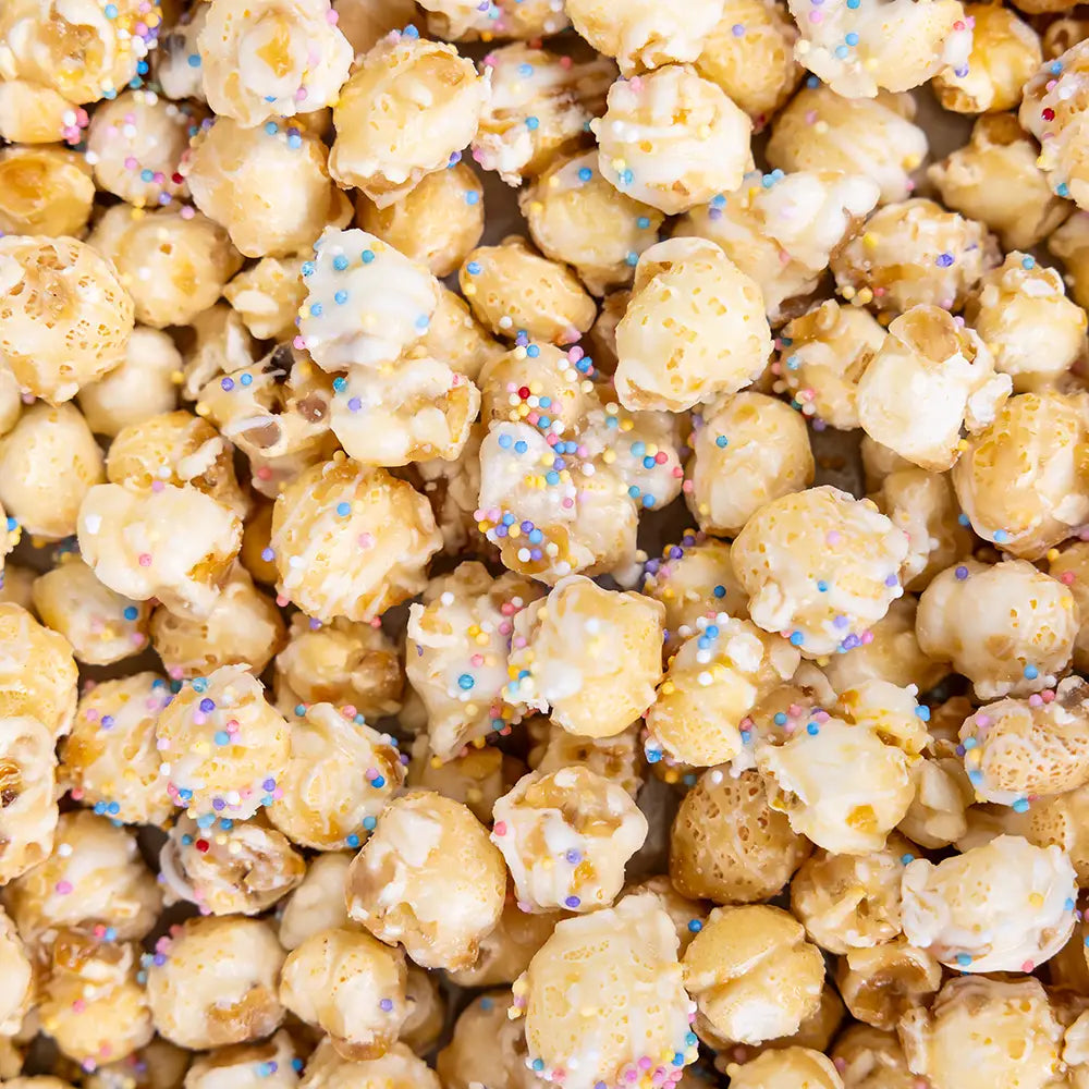 Poppy Handcrafted Popcorn frosted sugar cookie popcorn with colorful sprinkles