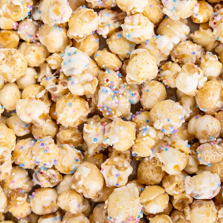 Poppy Handcrafted Popcorn frosted sugar cookie popcorn with colorful sprinkles