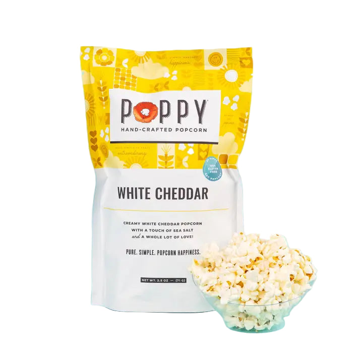 Poppy Handcrafted Popcorn White Cheddar bag with a bowl of gourmet cheesy popcorn on a blue background
