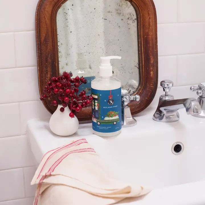 Soap & Paper Factory holiday hand and body wash displayed in a bathroom setting with decorative elements